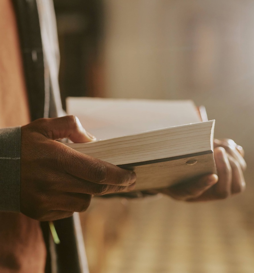 Close up of mans hands holding a Bible