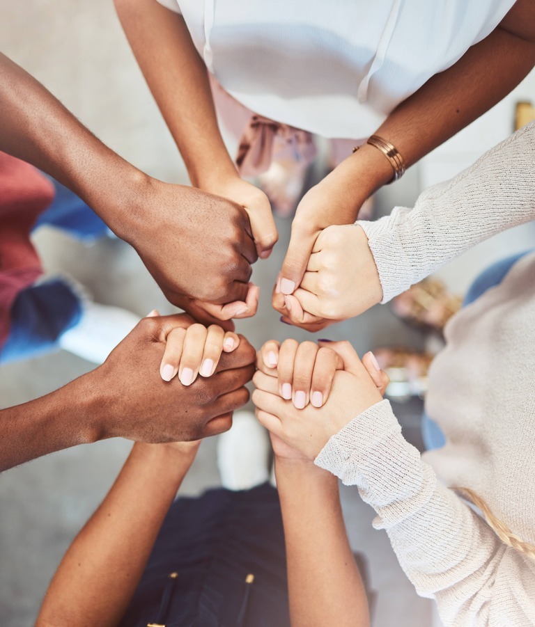 Diverse set of friends holding hands in center of image in support-1