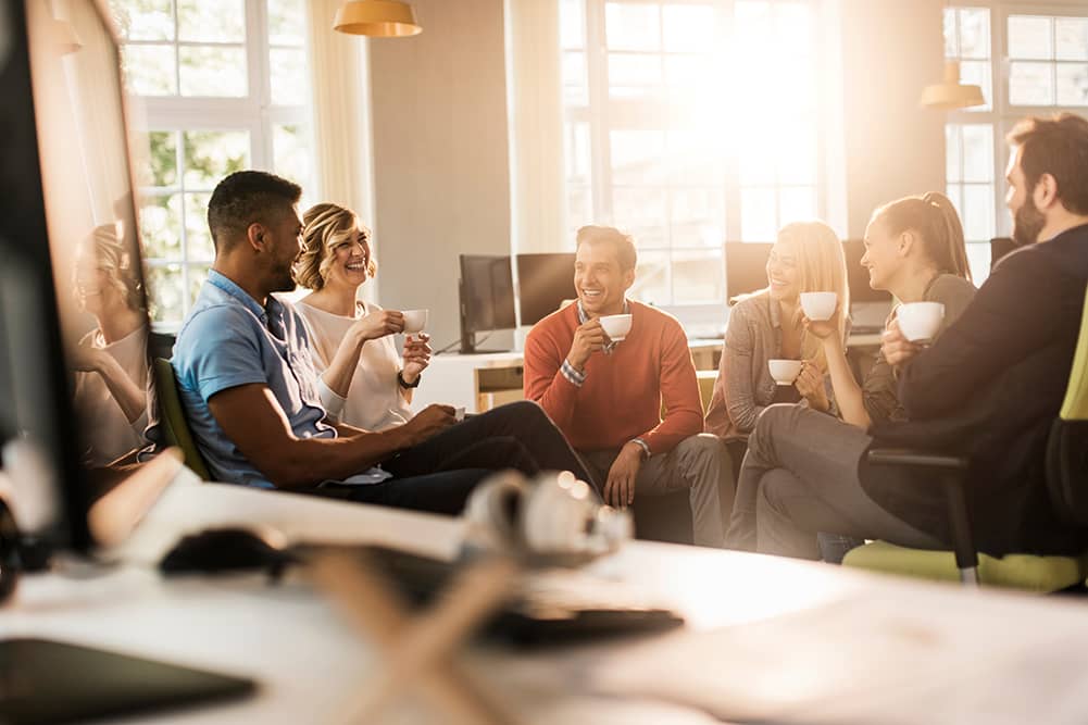 Group of friends drinking coffee and talking in a circle