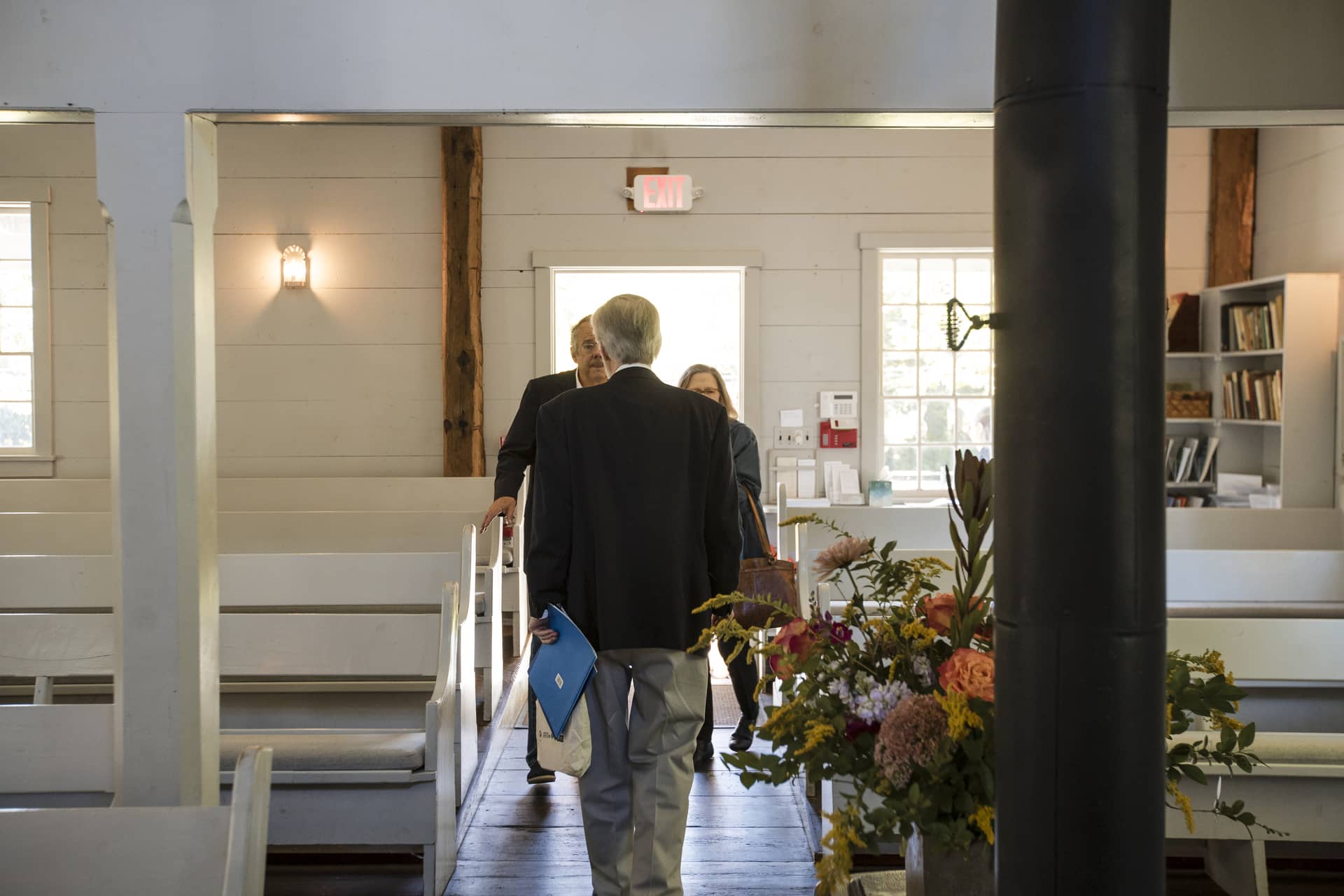Attendees walking out of the meeting house