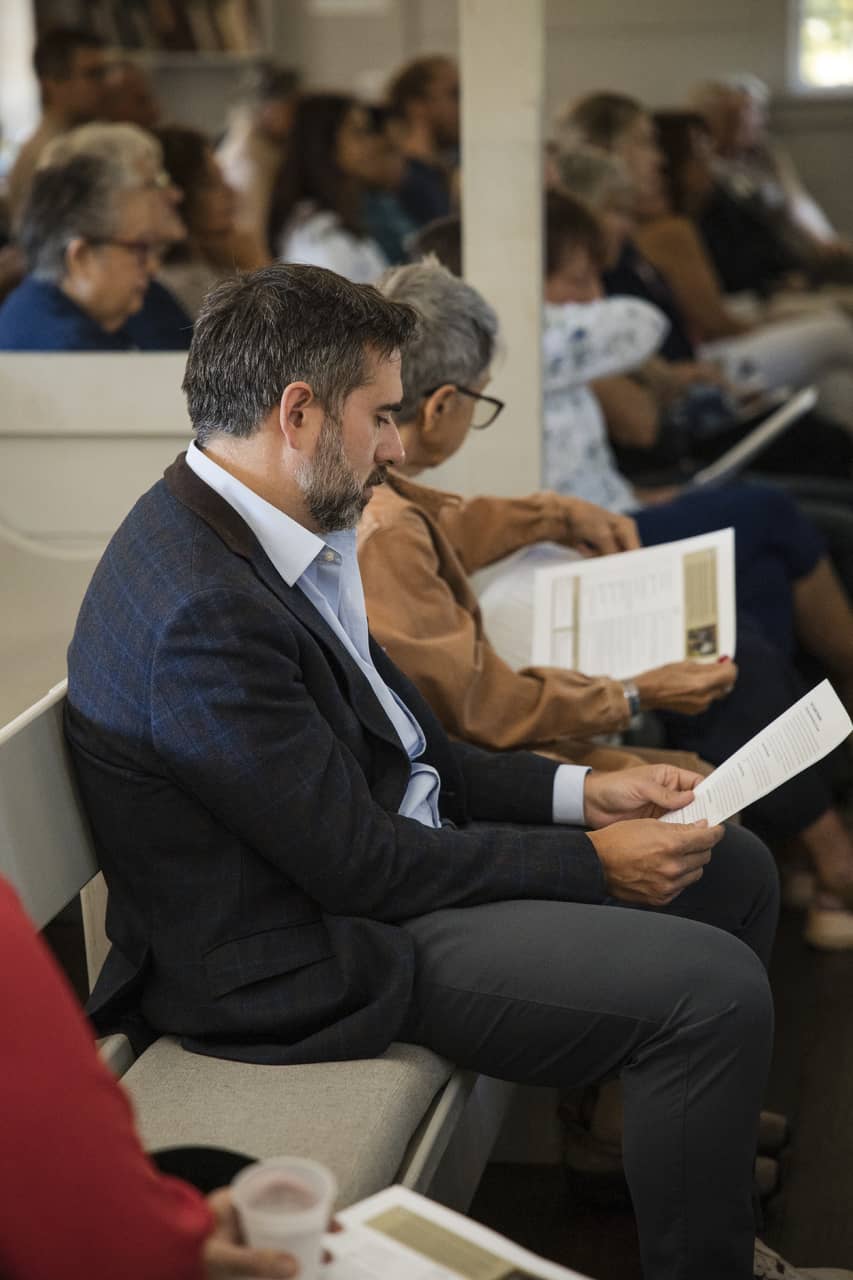 Event attendees reading pamphlets