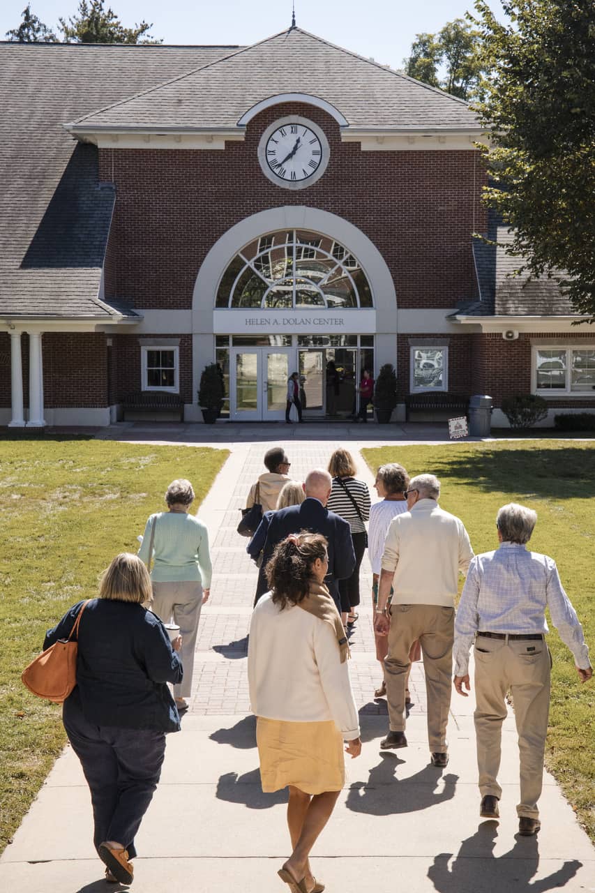 Group of people walking up to Dolan center