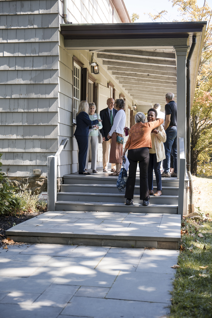 Attendees embracing outside meeting house