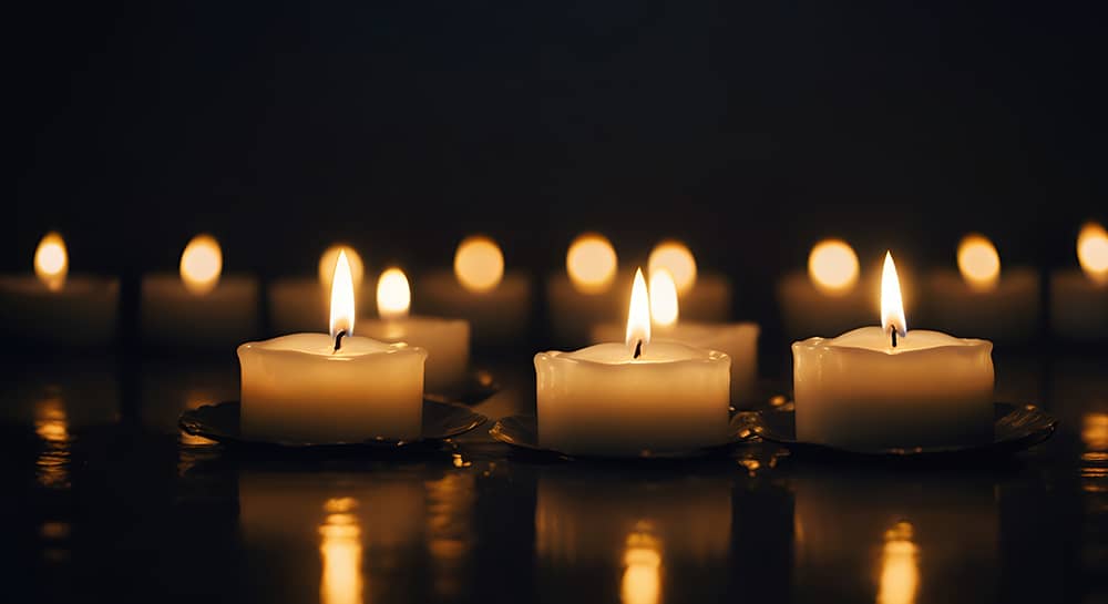 Dimly lit room with 3 small candles